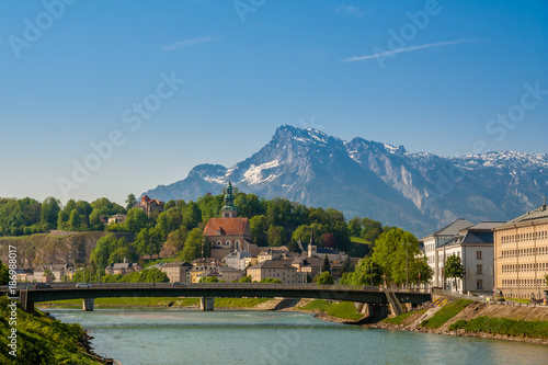 This photo shows Salzburg's Old Town next to the river Salzach and in the background lies the mountain Untersberg. 