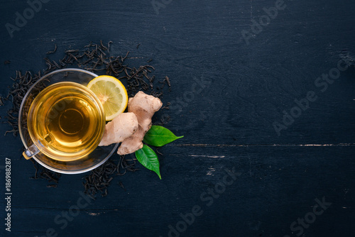 Tea with lemon and ginger. Hot drink On a wooden background. Top view. Copy space.