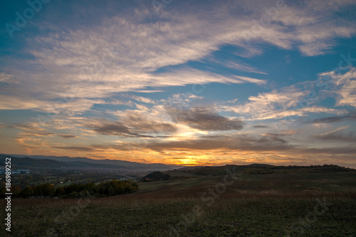 Romantic, bright and colorful sunset over a mountain range in Transilvania. Beautiful, colorful autumn background