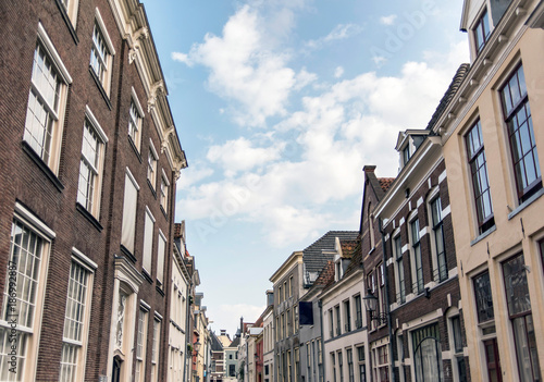 Street with old houses under blue cloudy sky. Deventer, Overijssel, Netherlands. © ysbrandcosijn