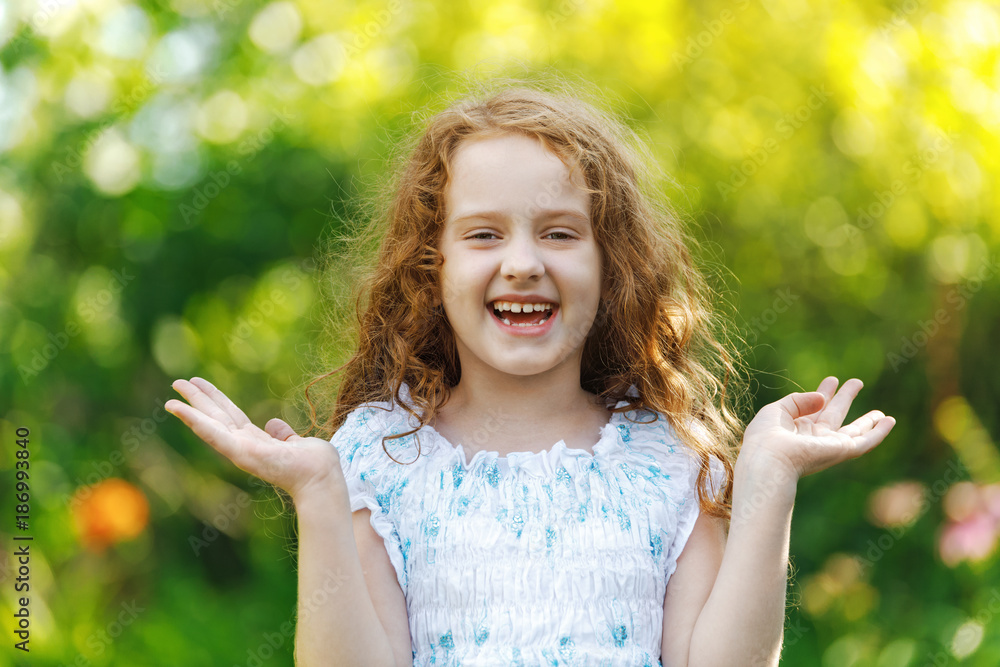 Surprised little girl  smiling and show white teeth. Healthy smiling, happy childhood concept.