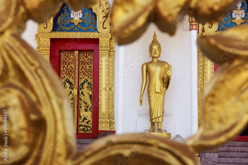 Thailand, Phuket, golden Buddha statue at Wat Putta Mongkon photo