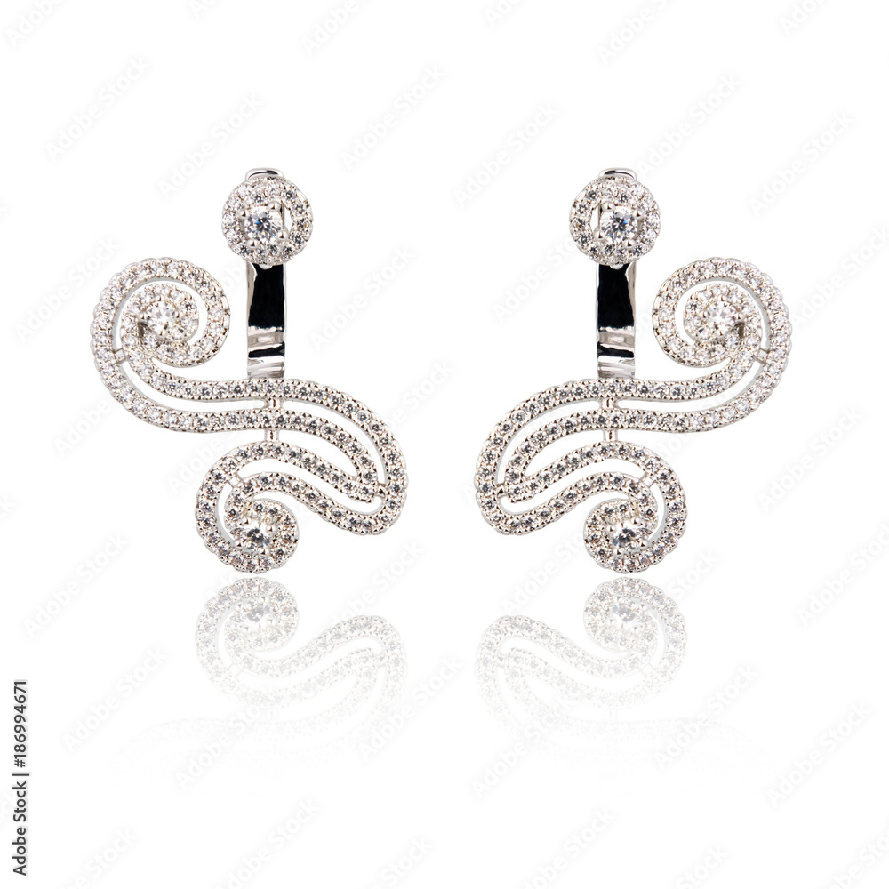 Pair of silver diamond earrings isolated on white Pair of silver diamond earrings isolated on white