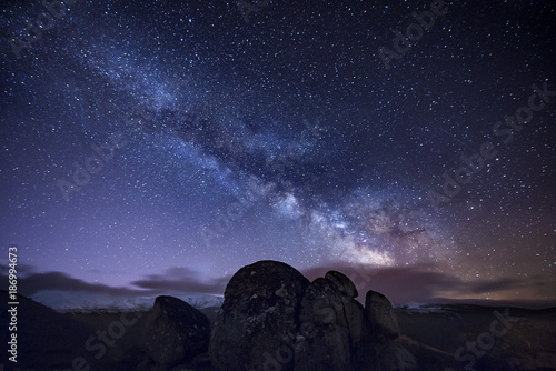 Milky way over ancient granite rocks photo