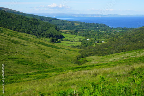 Fototapeta Naklejka Na Ścianę i Meble -  Scottish landscape with green rolling hills in the Isle of Arran, Scotland