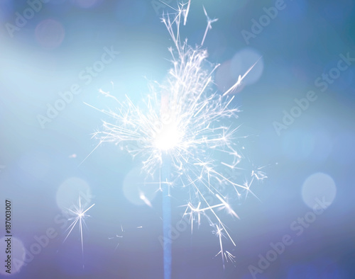 sparkler on blue bokeh background