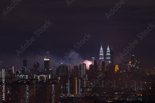 KUALA LUMPUR  MALAYSIA - 1ST JANUARY 2018  Fireworks explode near Malaysia s landmark Petronas Twin Towers during New Year celebrations in Kuala Lumpur.