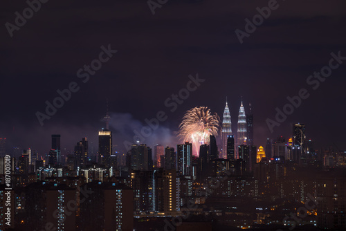 Photography KUALA LUMPUR, MALAYSIA - 1ST JANUARY 2018; Fireworks explode near Malaysia's landmark Petronas Twin Towers during New Year celebrations in Kuala Lumpur