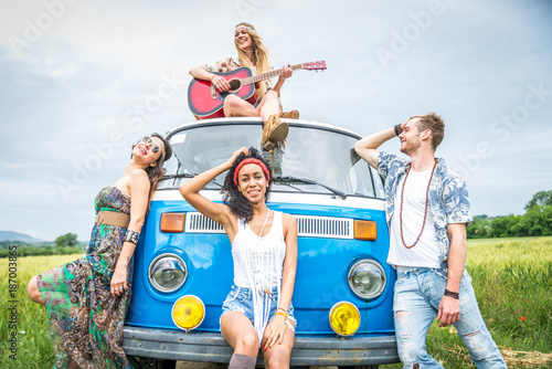 Happy friends driving a vintage minivan photo