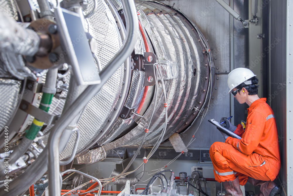 Offshore oil rig worker check and inspection gas turbine engine power generator for preventive maintenance. Stock Photo | Adobe Stock