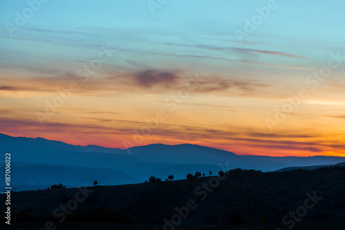Romantic  bright and colorful sunset over a mountain range in Transilvania. Beautiful  colorful autumn background