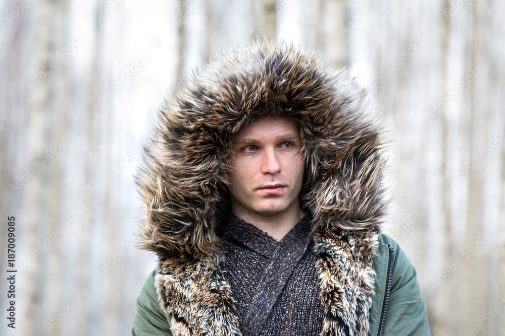Portrait of a young man in a fluffy winter parka. Portrait of a young man in a fluffy winter parka.