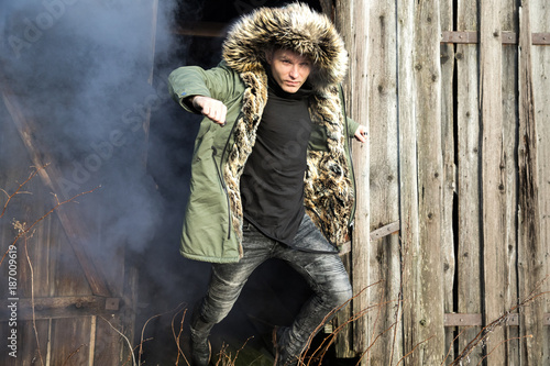 Young man posing with a smoke bomb.