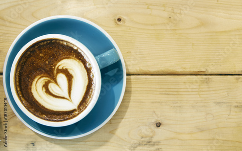 Hot coffee drawing heart in blue cup