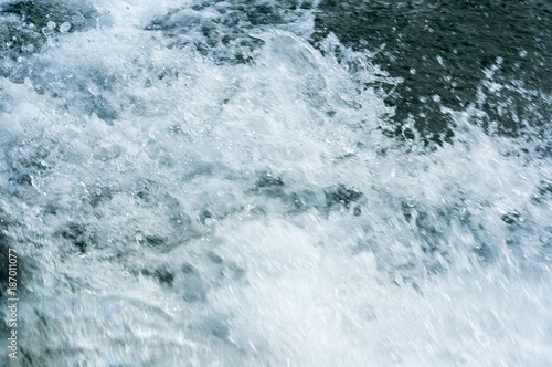 Detail water in motion by speed from boat to lake