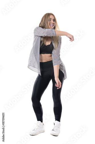 Billede på lærred Cheerful smiling woman dancing with tousled hair and unbuttoned shirt with closed eyes