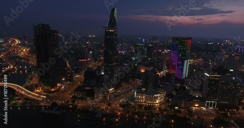 Wallpaper Mural HO CHI MINH CITY, VIETNAM – MAY, 2016 : Aerial shot of central Ho Chi Minh cityscape at night with skyscrapers and Saigon river in view Torontodigital.ca