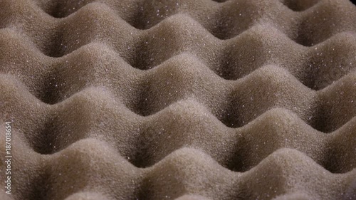 Amazing hilly surface of urethane foam with porous texture, rotating clockwise close up. Excellent abstract macro background with vibrant details of wavy packing material in UHD 4k, 3840x2160, clip.