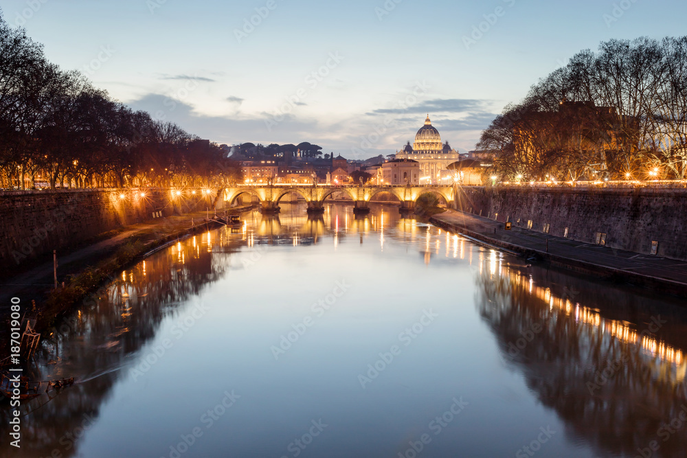 Rome cityscape at sunset, tiber river, San Pietro and Sant'Angelo bridge.