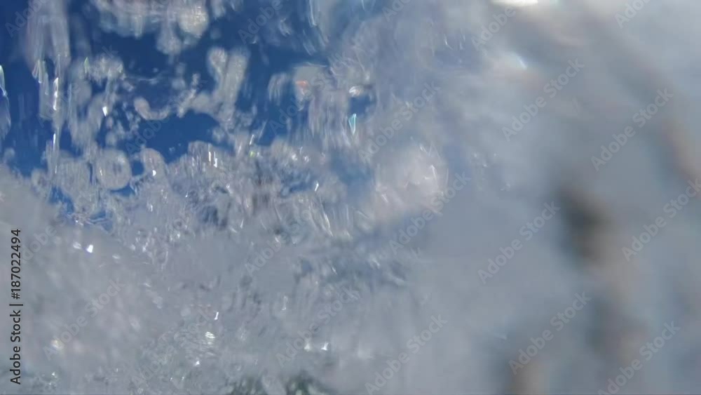 SLOW MOTION, LOW ANGLE: Focused male surfer carves a big ocean wave, splashes water on camera and cheerfully looks back. Young surfboarder is stoked after riding and carving a foaming barrel wave. SLOW MOTION, LOW ANGLE: Focused male surfer carves a big ocean wave, splashes water on camera and cheerfully looks back. Young surfboarder is stoked after riding and carving a foaming barrel wave.