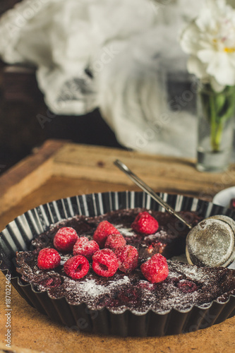 clafoutis chocolate with raspberry - brown cake photo