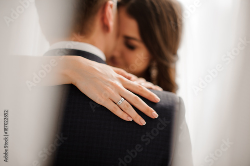 bride demonstrates her elegant diamond engagement ring photo