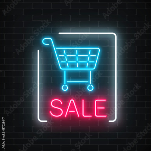 Neon glowing sale sign with shopping cart on a dark brick wall background. Big season discount neon banner.