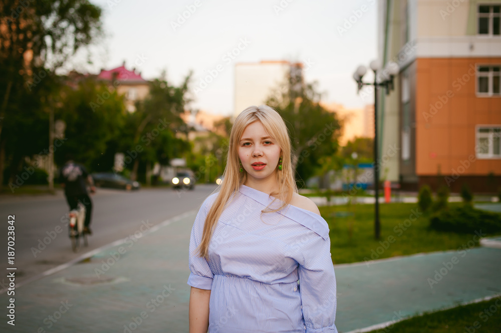 portrait of a cute young blond woman with a summer day