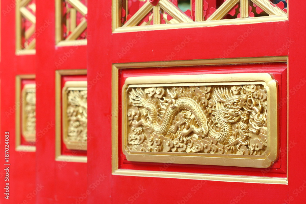 red chinese door have carve dragon golden color in temple