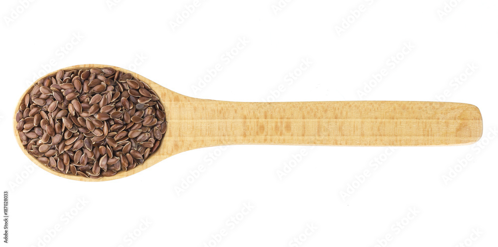 Flax seeds in wooden spoon isolated on white background close-up