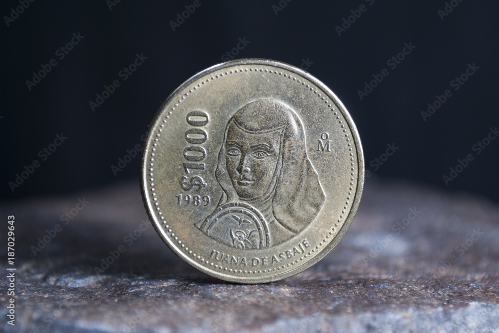 Mexican coin 1000 pesos of 1989 currency over stone texture