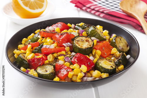 Vegetable salad of roast courgette or zucchini, roasted red capsicum or pepper, sweetcorn and red onion with toasted cumin seeds.