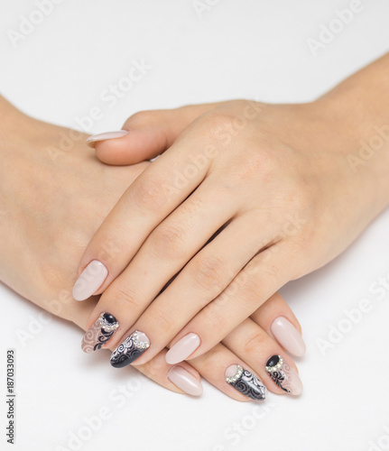 Abstract floral pattern on pink nails black.