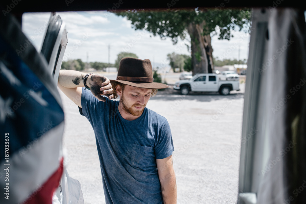 Modern American cowboy outside his van after working Modern American cowboy outside his van after working