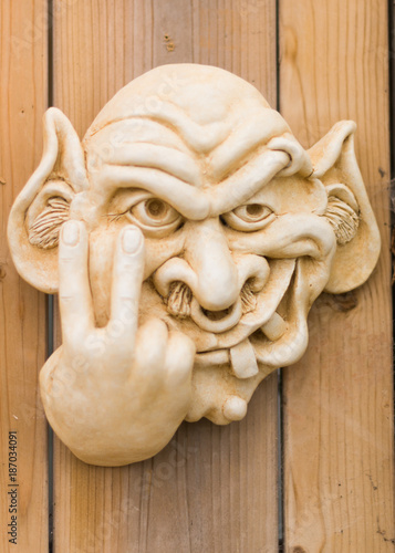 Rude gremlin making nasty gesture