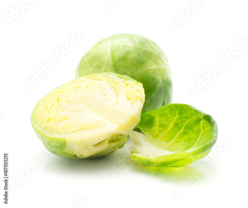 Boiled Brussels sprout head one half and separated leaf isolated on white background.