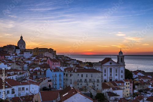 View of the Alfama neighborhood from the Portas do Sol viewpoint at sunrise in Lisbon, Portugal; Concept for travel in Portugal, visit Portugal and most beutiful places in Portugal