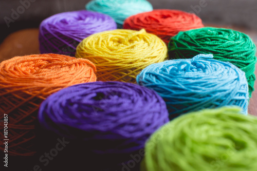 Bright , vibrant rolls of yarn on a table