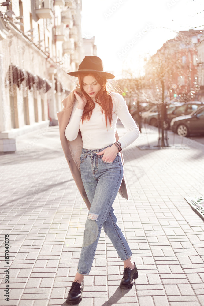 fashionable girl in the city in the sun. bright image of city life