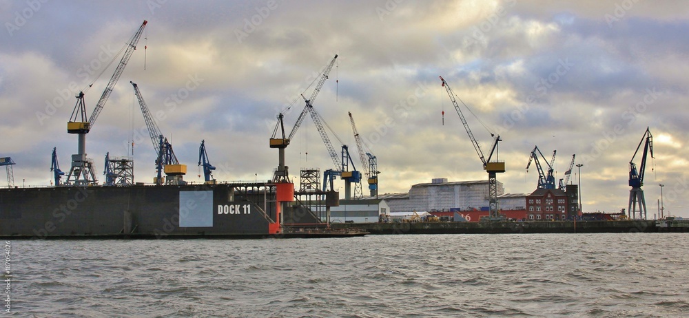 Industrial scene at the Elbe, Hamburg. Harbour cranes. View from Altona.