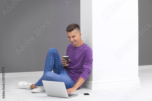 Young man using laptop and ...