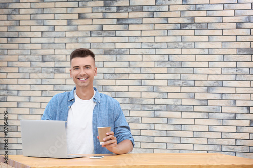 Young man using laptop in o...
