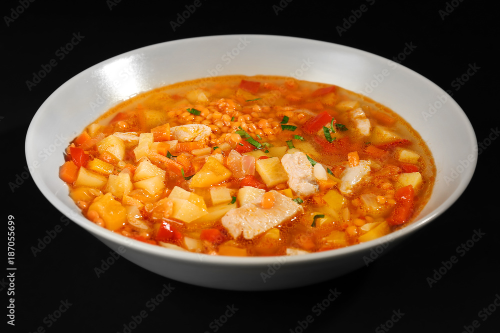 Plate with tasty lentil soup on black background Plate with tasty lentil soup on black background