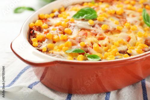 Baking dish with corn pudding on table, closeup