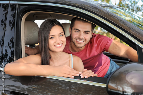Beautiful young couple in car