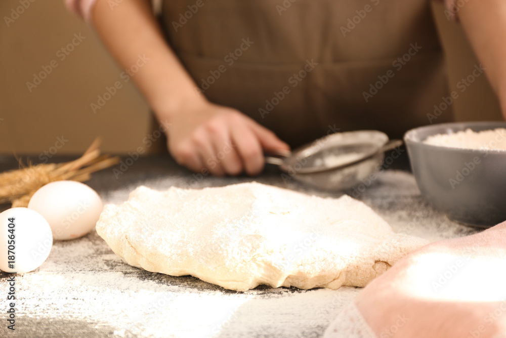Raw puff pastry and woman at table Raw puff pastry and woman at table