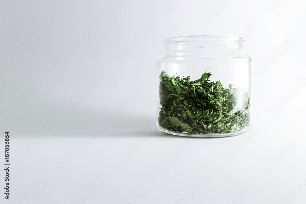 Dry melissa and mint tea in the jar isolated on white background. Homemade and healthy Dry melissa and mint tea in the jar isolated on white background. Homemade and healthy