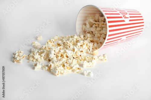 Paper cup with tasty popcorn on white background