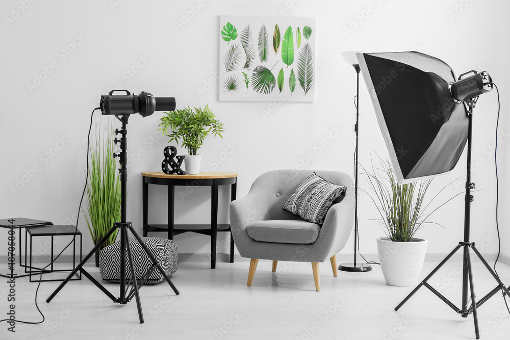 Interior of modern photo studio with armchair and professional equipment - obrazy, fototapety, plakaty 