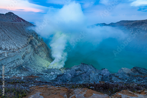 Sunrise at Kawah Ijen volcano crater with sulfur fume. Ijen crater the famous tourist attraction near Banyuwangi, East Java, Indonesia